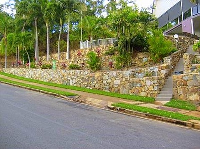 Road view of stone design retaining wall Northern Land Design
